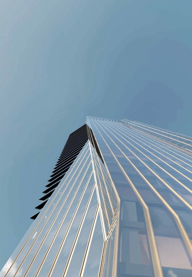 Low-angle architectural view of a modern glass skyscraper with vertical gold accents against a clear blue sky.