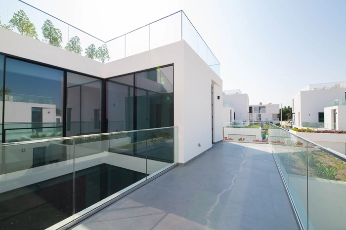 Modern Residential Rooftop Terrace with Glass Railings and Minimalist White Architecture